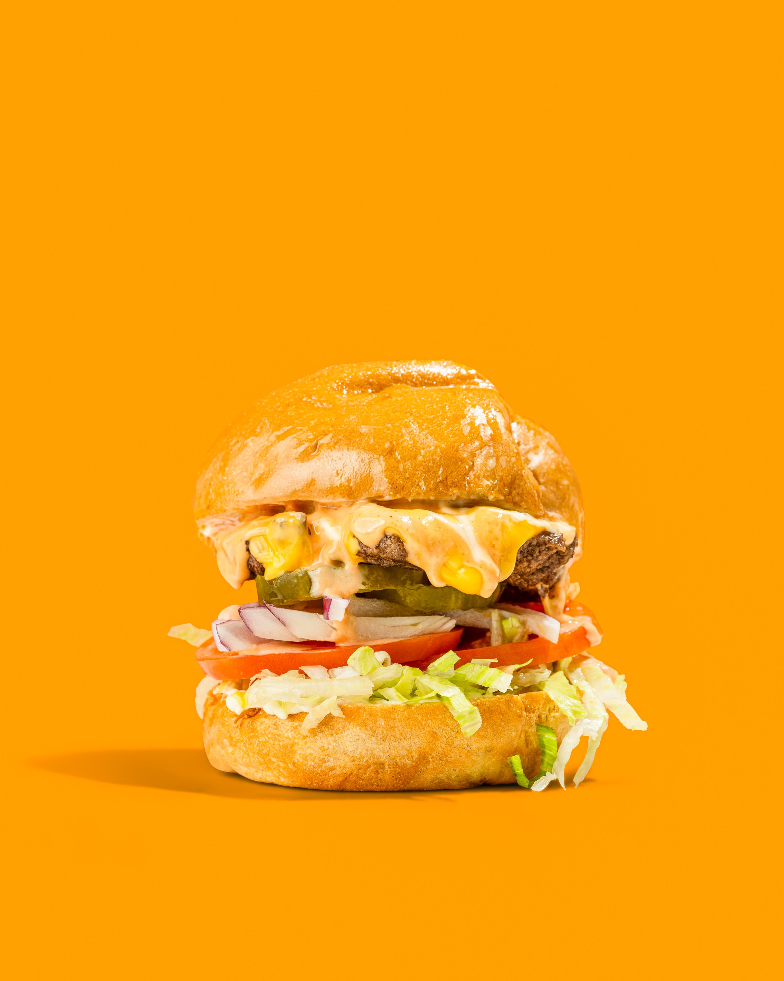 Hero shot of popular burger from New York City based restaurant named Krazy Grill, located in The Bronx. 
Photographed by Kyran John for Foreign Kollective Media Group